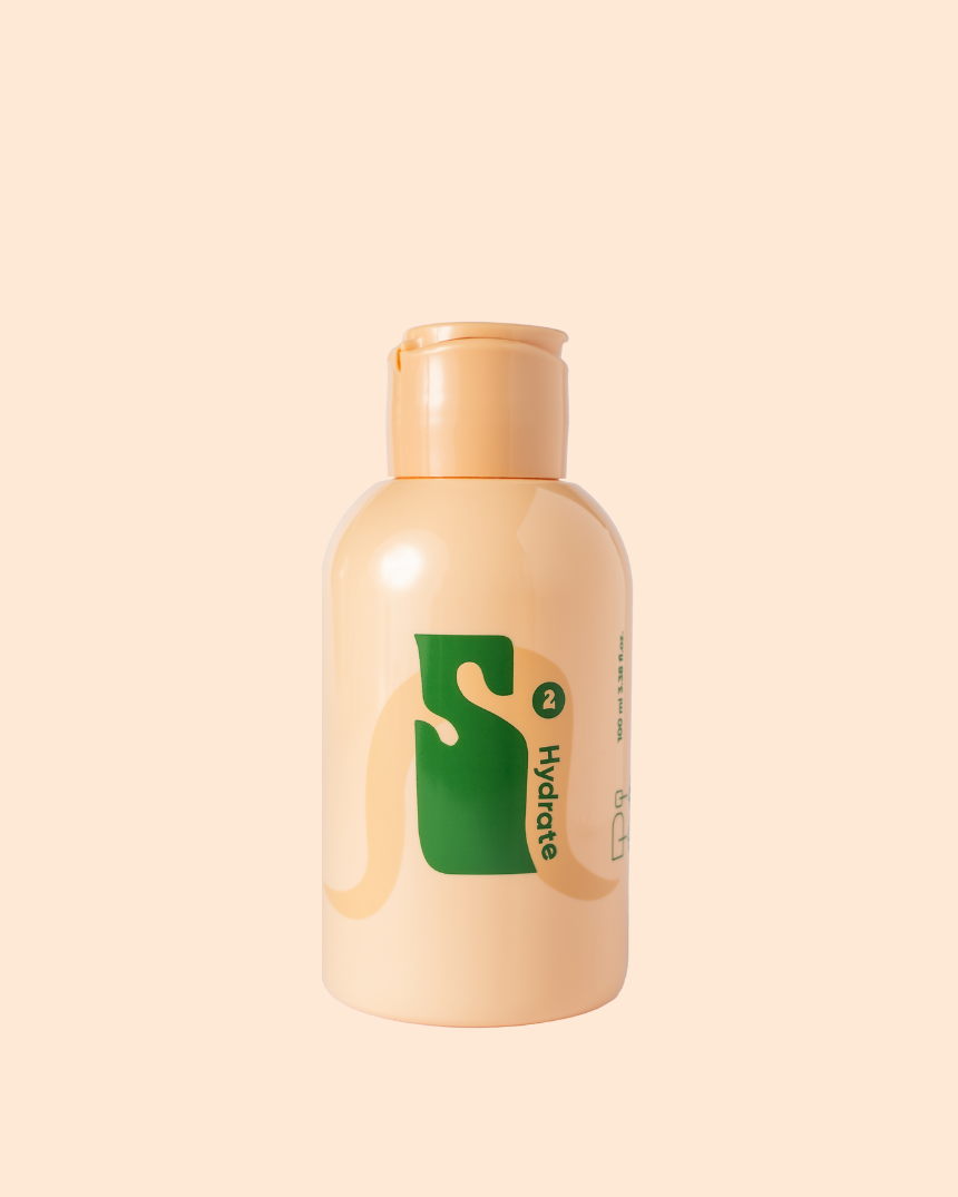 A beige Savaip skin skincare bottle with a peach-colored cap, showcasing a vibrant green logo and labeled "Level-Up Serum in Toner", set against a soft peach background.
